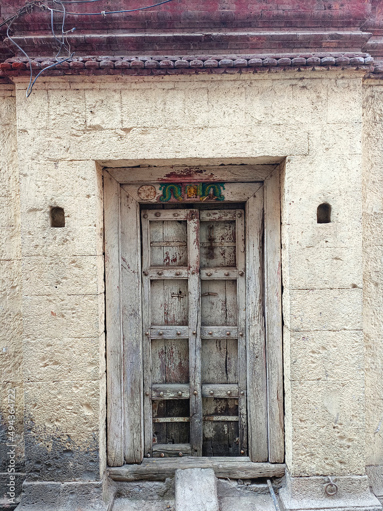 Fototapeta premium 21 March 2022, Pandharpur, India, Old Vintage wooden door on retro wall, Pandharpur, India.