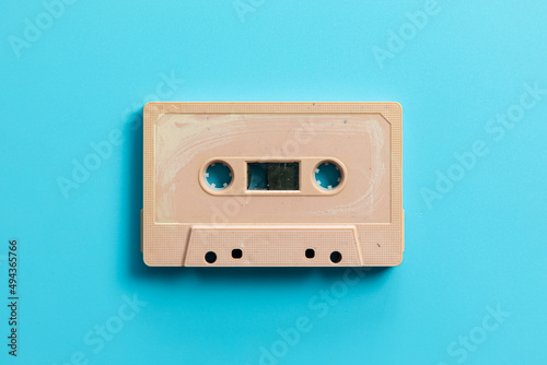 Vintage audio cassette on blue background