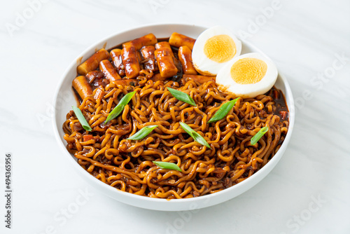 Jjajang Rabokki - Korean instant noodles or Ramyeon with Korean rice cake or Tteokbokki and egg in black bean sauce photo