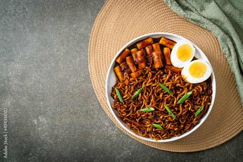 Jjajang Rabokki - Korean instant noodles or Ramyeon with Korean rice cake or Tteokbokki and egg in black bean sauce photo