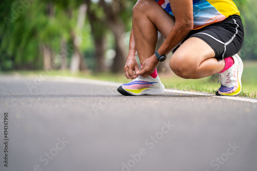 Close up of Senior Man tying running shoes.