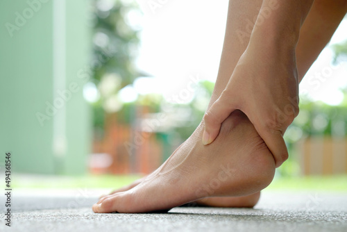Wallpaper Mural A woman holding her ankle Have muscle pain and tendon around the ankle Torontodigital.ca