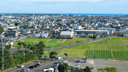 Scenery of Yoshida city, taken from Koyama castle, with blue sky. Cityscape with many of buildings, hills, urban scene, townscape, city skyline.