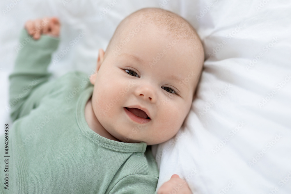 The baby lies on the bed. Little baby. High quality photo The baby lies on the bed. Little baby. High quality photo