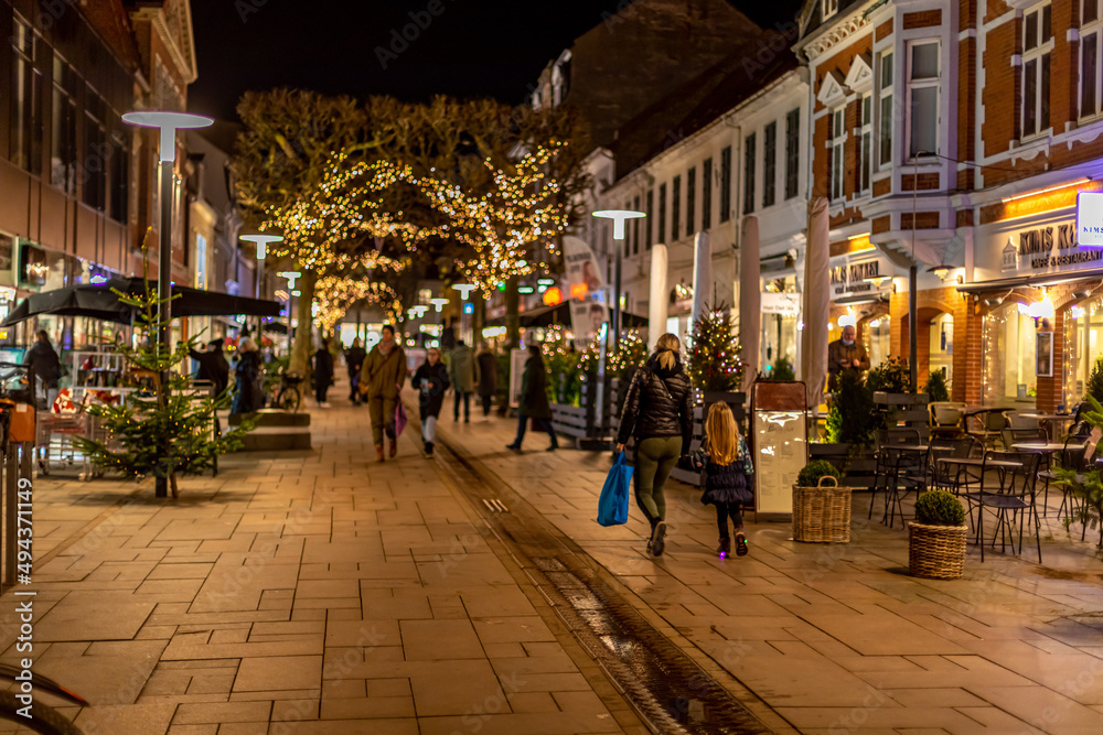 Fredericia, DENMARK - 16 December 2021 - Here are people on the pedestrian street, with spruce trees