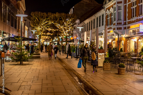 Fredericia, DENMARK - 16 December 2021 - Here are people on the pedestrian street, with spruce trees photo