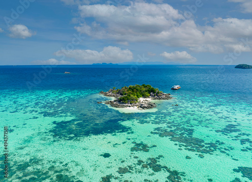 Aerial top view of Isolated beautiful tropical island with white sand beach and blue clear water and granite stones