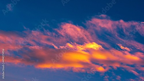 Fototapeta Naklejka Na Ścianę i Meble -  colorful dramatic sky with clouds, smoking cumulonimbus clouds reflect the golden light of the dawn sun.	
