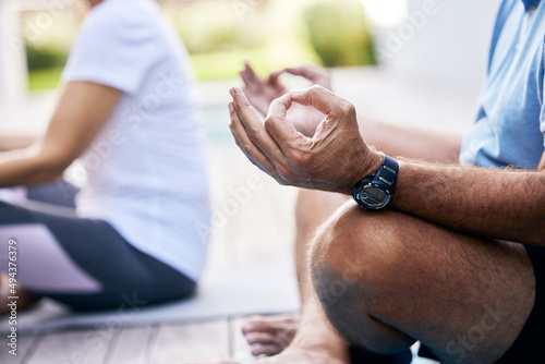 Yoga will allow you to find clarity in your life. Closeup shot of an unrecognisable couple meditating outdoors.