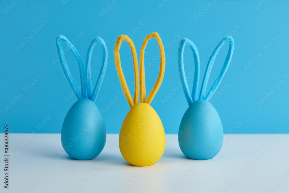 Blue and yellow Easter eggs with bunny ears, holiday decoration Blue and yellow Easter eggs with bunny ears, holiday decoration