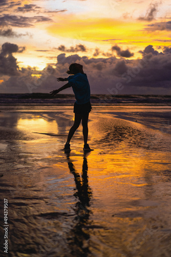Beautiful young woman at sunset on the ocean, Bali, Indonesia. © Yuliya Kirayonak