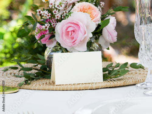 Mockup white blank space card, for Name place, Folded, greeting, invitation on wedding table setting background. with clipping path photo