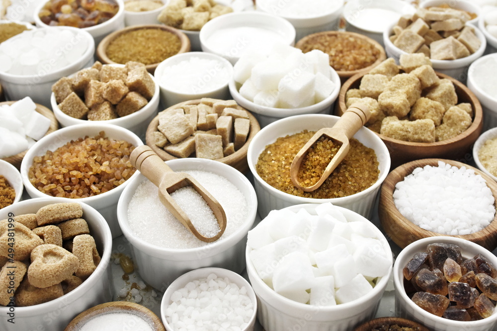 Fototapeta premium Mix of sugar varieties: unbleached, brown and white, refined and unrefined, granulated and cubes