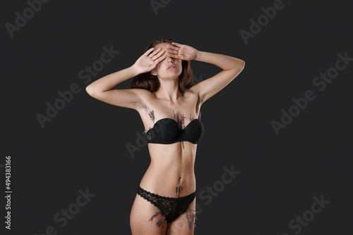 Hairy unshaven female armpits. Body positive trend. Woman wearing bra raised her hands. Acceptance of love body love love. Depilation. On a black background photo