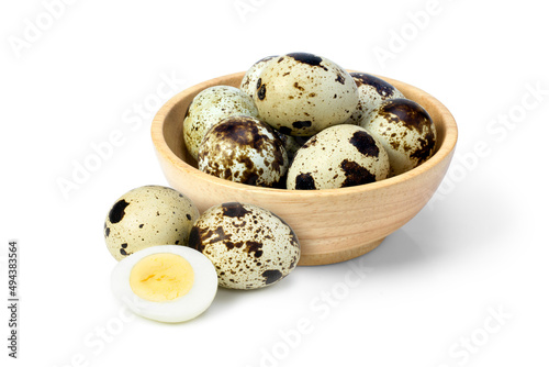 quail eggs in a bowl on white
