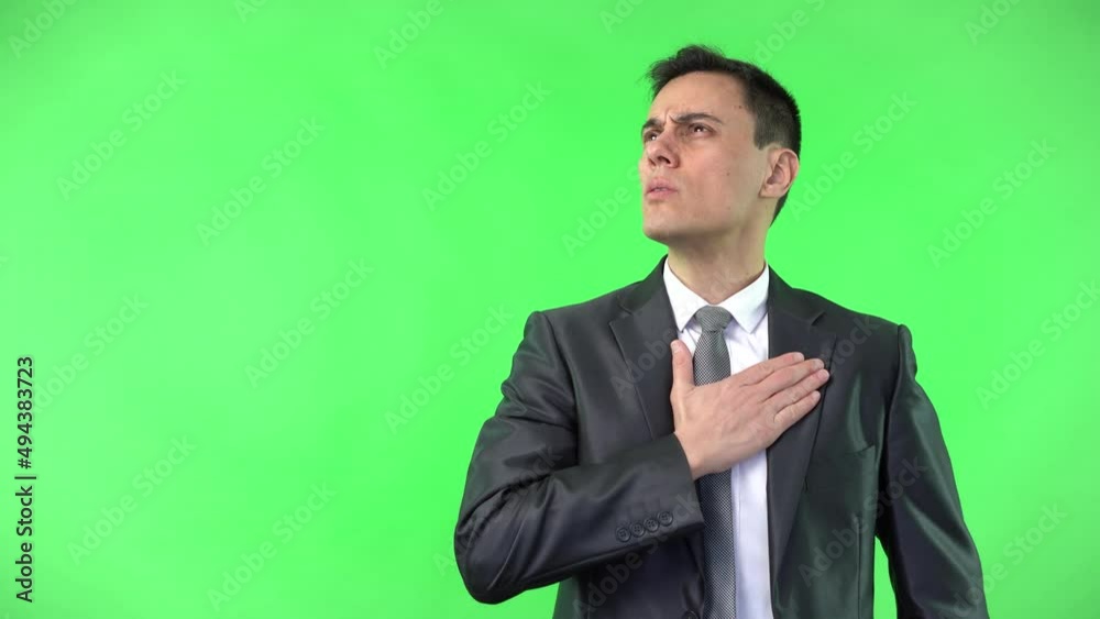 Serious man in suit keeping hand on heart showing honesty Serious man in suit keeping hand on heart showing honesty