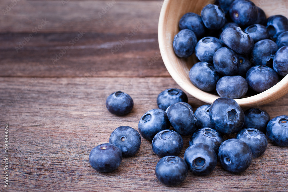 blueberries in a wooden bowl blueberries in a wooden bowl