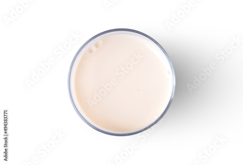 Glass of fresh soy milk isolated on white background. Top view. Flat lay.