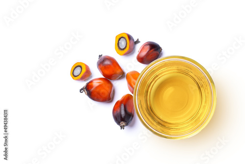 Palm oil in glass bowl and fresh palm fruit solated on white background. Top view. Flat lay. photo
