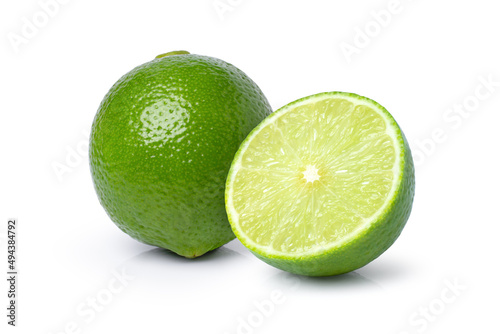 Fresh green lime fruit and cut in half sliced isolated on white background.