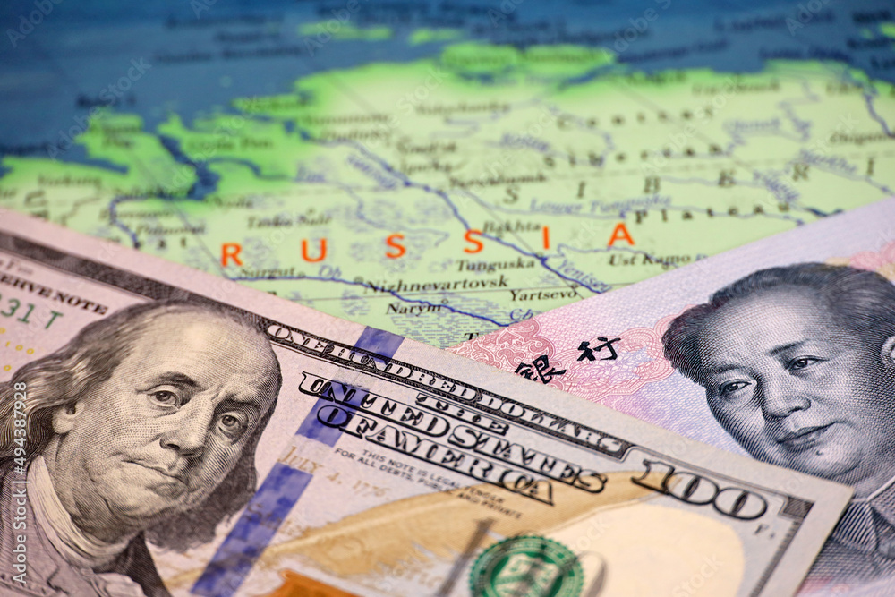 Chinese yuan and US dollar on the map of Russia. Concept of economic cooperation between the Beijing and Moscow during american sanctions due conflict in Ukraine Chinese yuan and US dollar on the map of Russia. Concept of economic cooperation between the Beijing and Moscow during american sanctions due conflict in Ukraine
