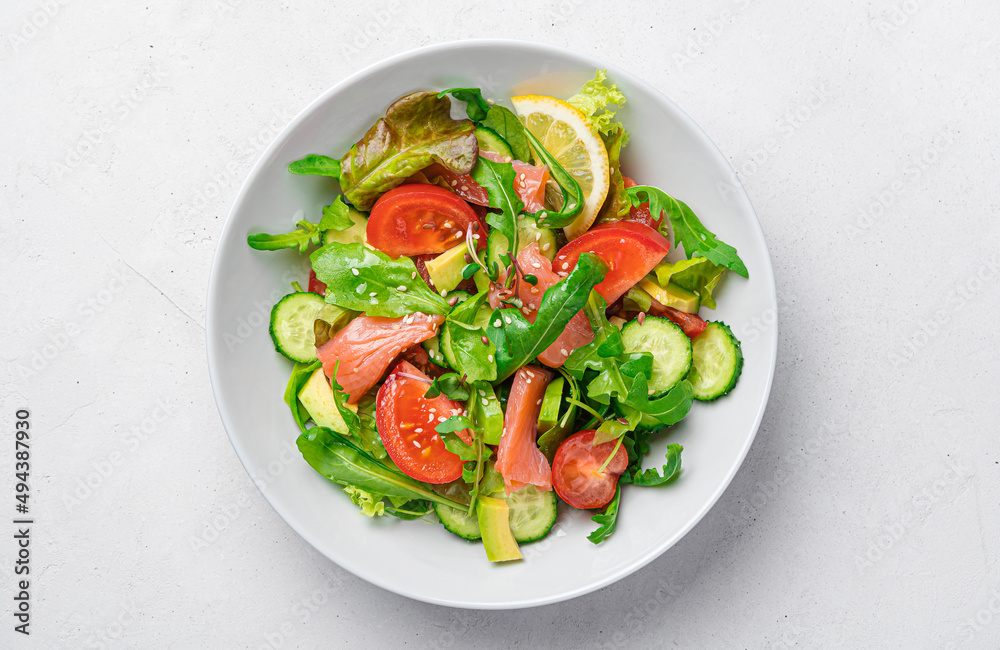Salad with salmon, avocado, tomatoes, fresh herbs and sesame flax seeds. Salad with salmon, avocado, tomatoes, fresh herbs and sesame flax seeds.