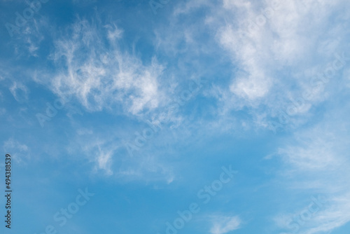 Light blue sky with white clouds. Art sky background for celebration and season decoration. A backing of vanilla sky for branding, calendar, card, post, cover, website, a place for your design or text