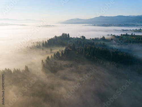 Morning mist in Ukrainian Carpathian mountains. Aerial drone view.