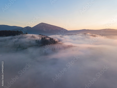 Sunrise over the fog in the Ukrainian Carpathians. Aerial drone view.