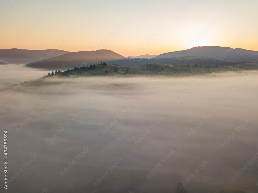 Sunrise over the fog in the Ukrainian Carpathians. Aerial drone view. Sunrise over the fog in the Ukrainian Carpathians. Aerial drone view.