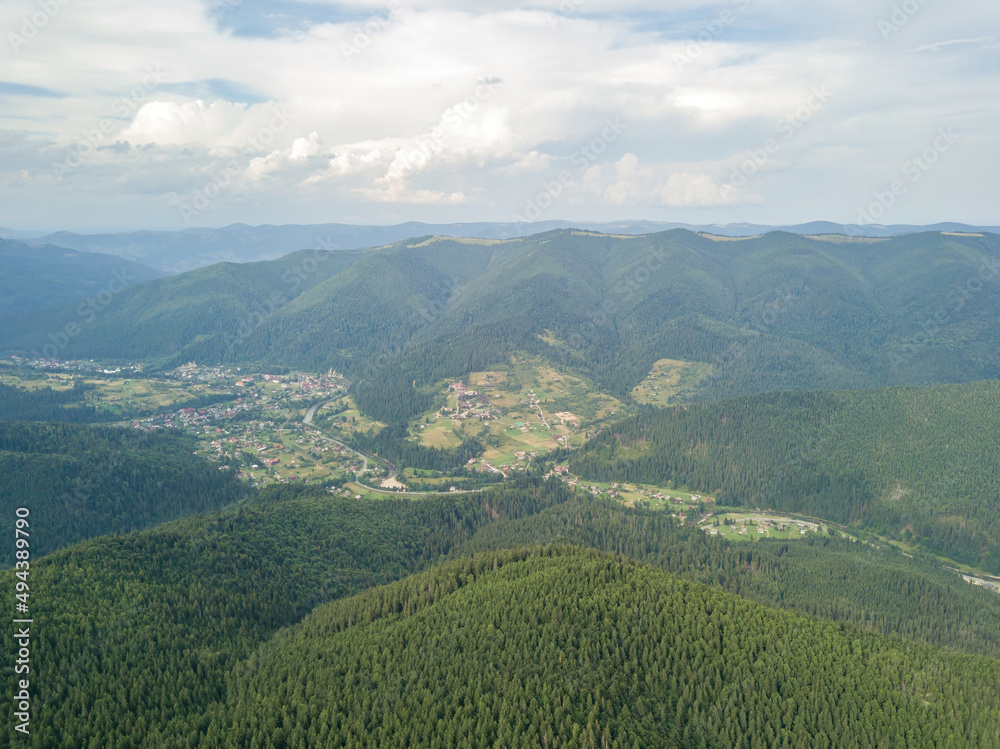 Fototapeta premium Green mountains of Ukrainian Carpathians in summer. Aerial drone view.