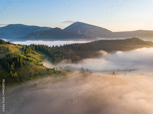 Sunrise over the fog in the Ukrainian Carpathians. Aerial drone view.