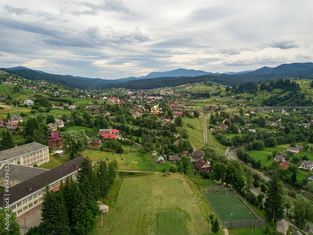 Fototapeta premium Settlement in the mountains of the Ukrainian Carpathians. Aerial drone view.