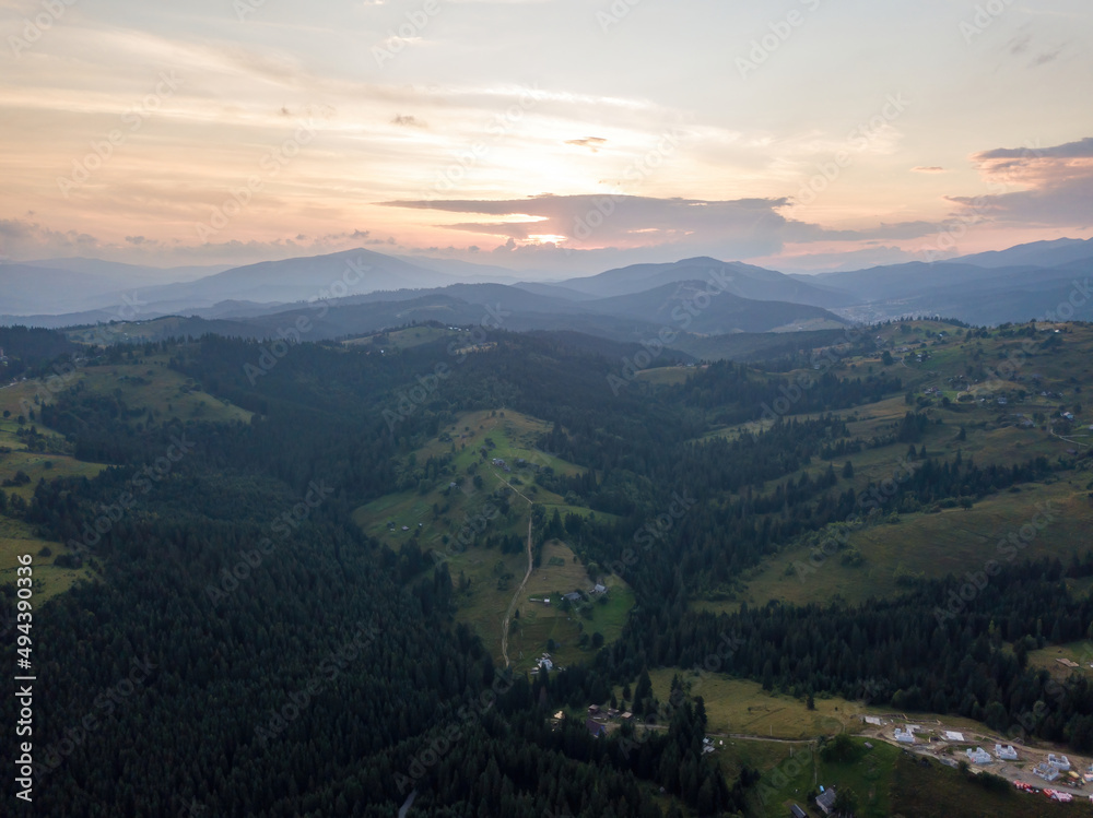 Fototapeta premium Sunset over the mountains in the Ukrainian Carpathians. Evening. Aerial drone view.