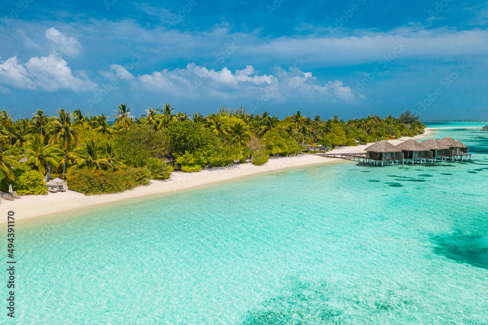 Beautiful atoll and island in Maldives from aerial view. Tranquil tropical landscape and seascape with palm trees on white sandy beach, amazing nature in luxury resort villa. Summer travel vacation