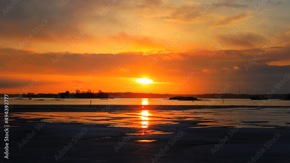 Ice on Fire - Dramatic Sunrise over Partly Frozen Sea in the Spring. 