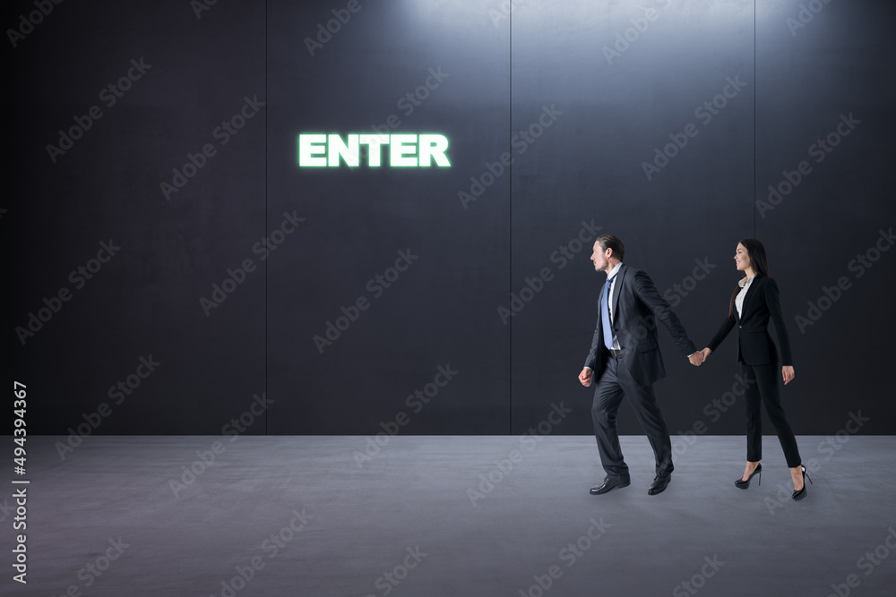 Obraz premium Thoughtful young businesspeople standing in concrete interior with entrance to success. Way and opportunity concept.