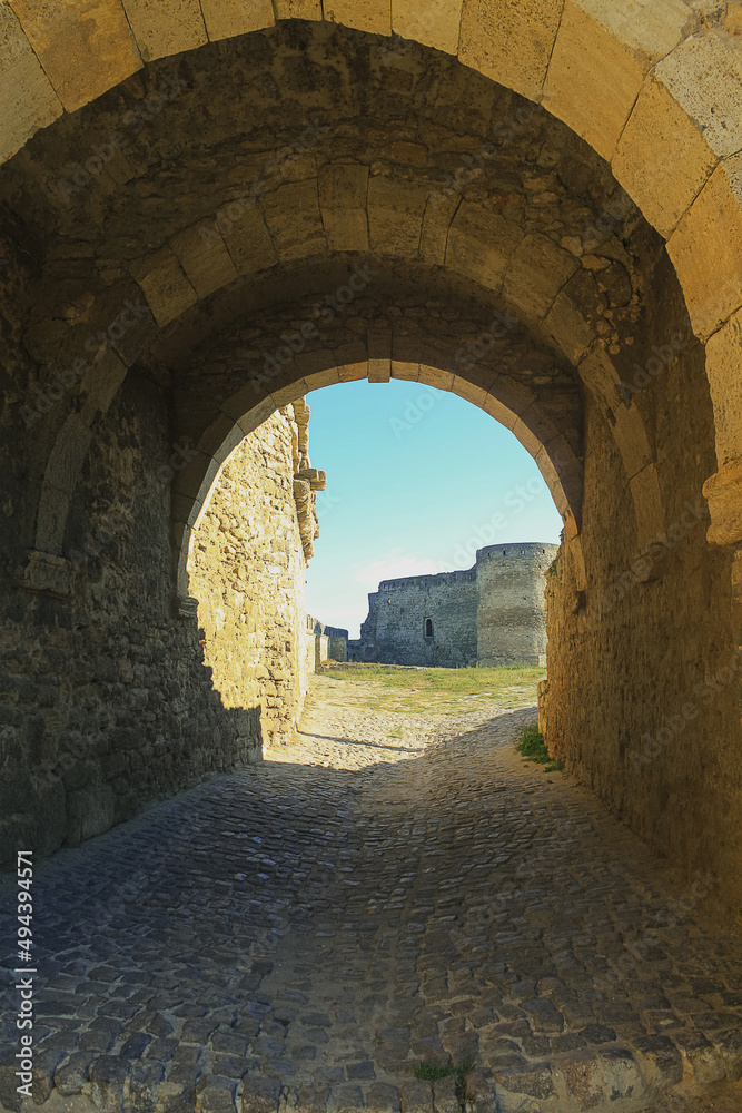 One of the entrances to the Belgorod-Dnestrovskiy fortress Akkerman. Gate arch and stone sidewalk. Medieval castle by the sea.