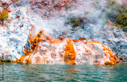 Small active volcano nearly submerge in the water