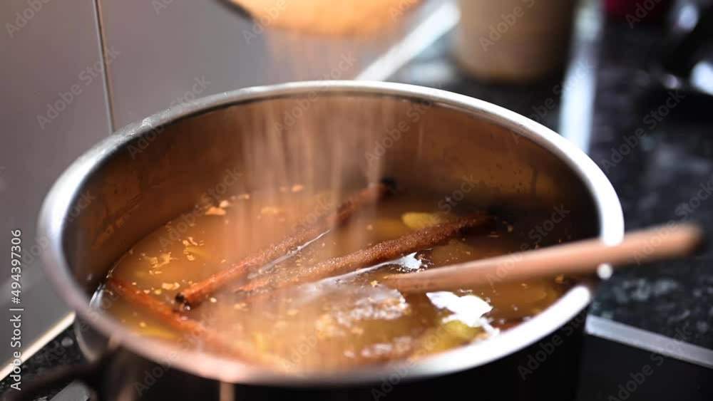 Traditional ginger and cinnamon drink, adding sugar slowly to delicious drink. Close up shot Traditional ginger and cinnamon drink, adding sugar slowly to delicious drink. Close up shot