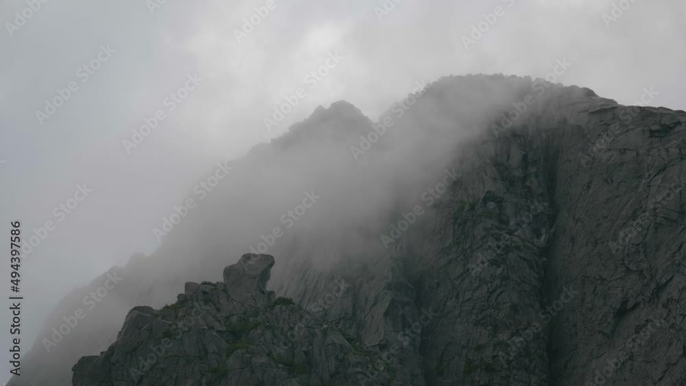 Huge granite walls with clouds passing by. Huge granite walls with clouds passing by.