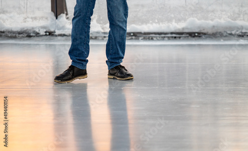 Ice, feet in boots on ice, slippery. Winter.