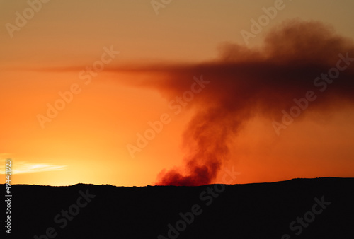 Fire over the horizon at sunset silhouette
