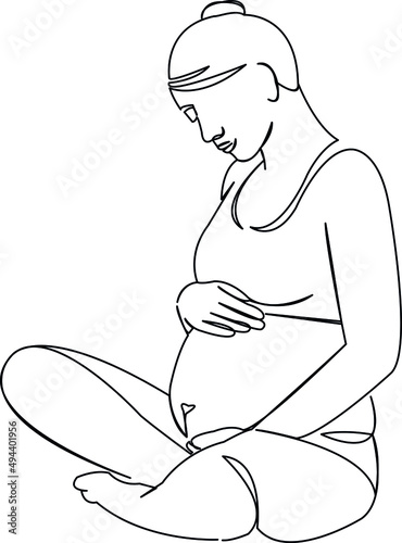a pregnant woman sits in a lotus and strokes her belly