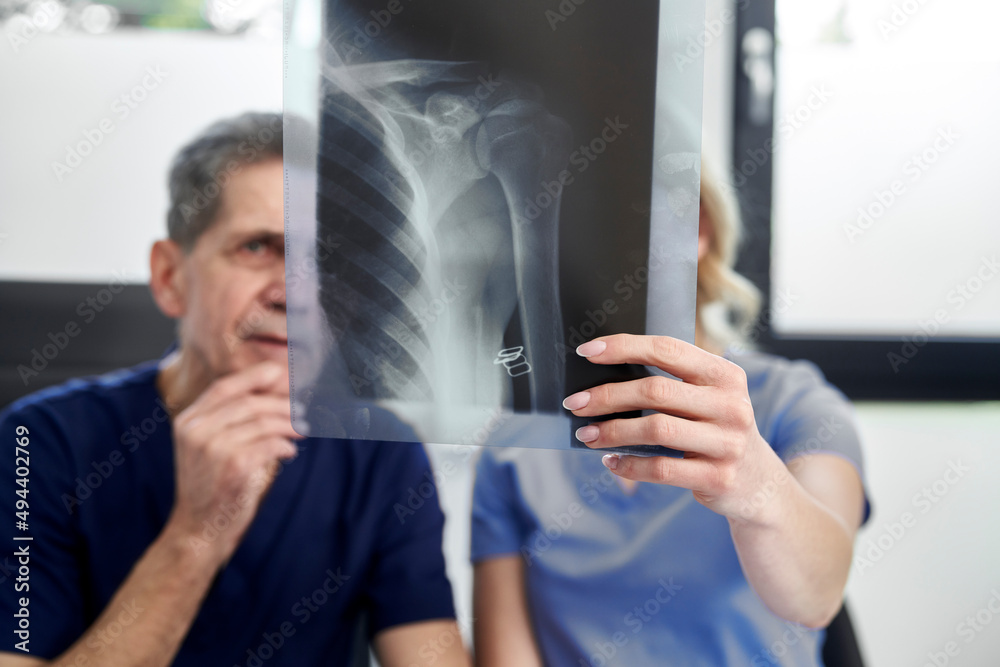 Two caucasian doctors discussing abut X-ray image Two caucasian doctors discussing abut X-ray image