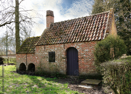 traditional Flemish farmhouse in a rural landscape