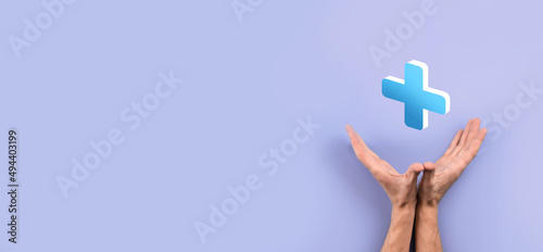 Businessman hold 3D plus icon, man hold in hand offer positive thing such as profit, benefits, development, CSR represented by plus sign.The hand shows the plus sign