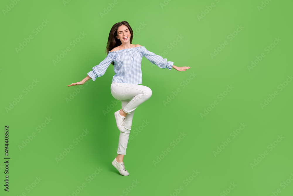 Full size photo of cute carefree energetic girl spend summer holidays go traveling isolated on green color background