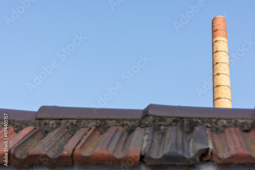 a chimney over a roof of a house
