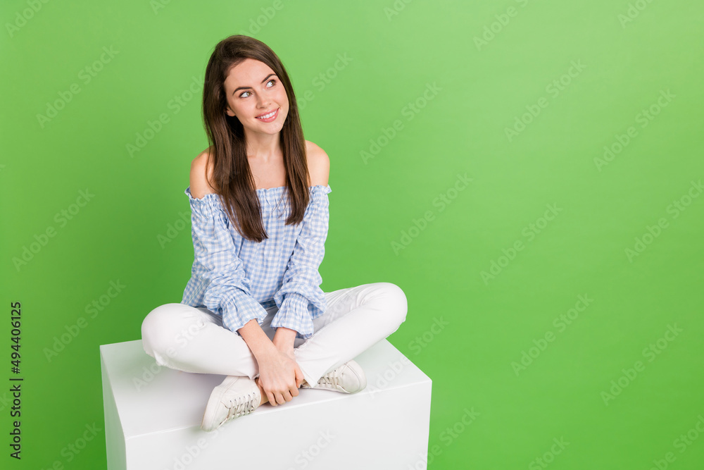 Photo of cute sweet positive female look blank space see product advert sale discount isolated on green color background Photo of cute sweet positive female look blank space see product advert sale discount isolated on green color background